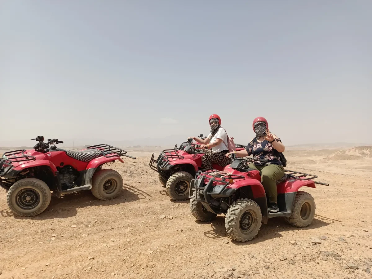 Quad-Safari in der ägyptischen Wüste mit Touristinnen auf roten Quads.