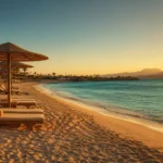 Sonnenuntergang am Strand von Hurghada mit Liegestühlen und Palmen im Mai